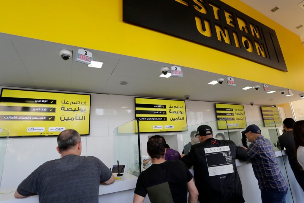 People gather at a Western Union outlet in the Lebanese capital Beirut on 9 November 2019